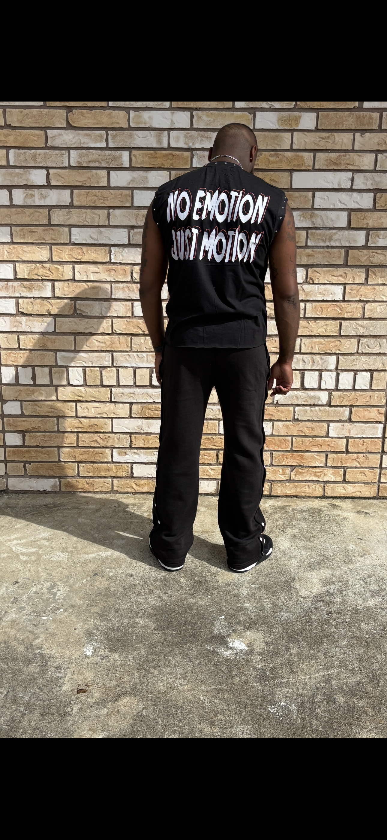 cut of sleeveless shirt with flared cotton pants